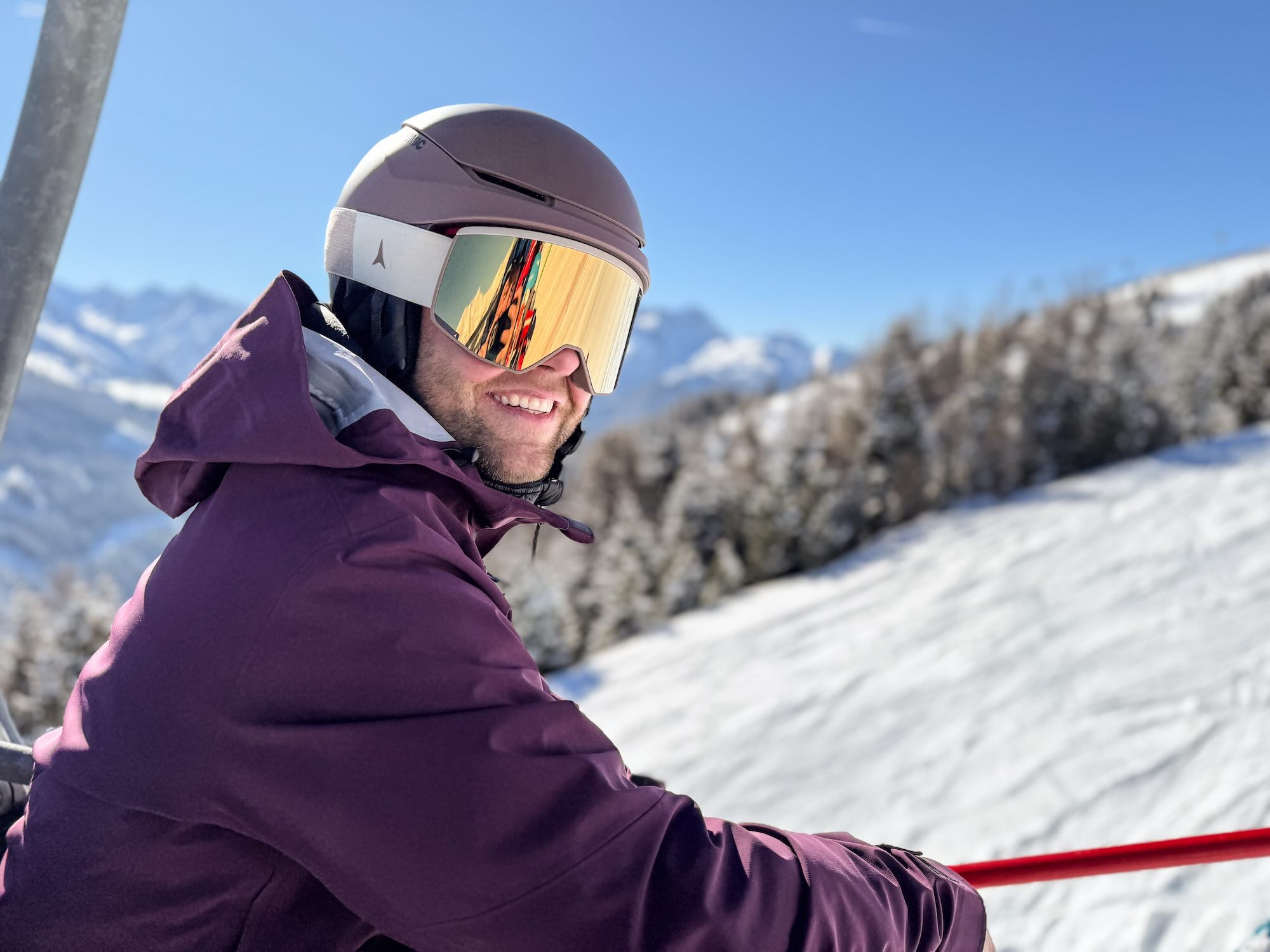 Skifahrer mit Helm und Brille im Sessellift
